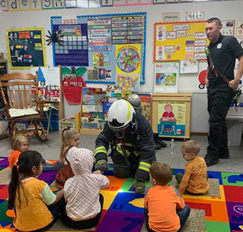Fire officers teaching students in a classroom