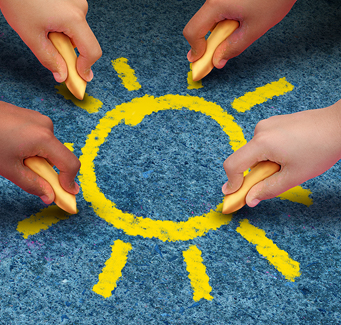 little hands drawing a sun with sidewalk chalk
