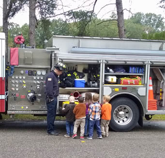 children looking at a fire truck