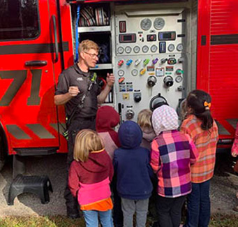 children looking at a fire truck